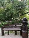 Beautiful bench in the zoo with a pensive monkey